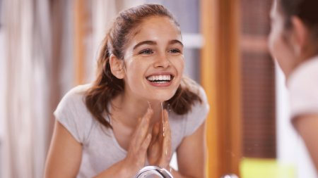 Tu piel - adolescente sonriendo en el espejo Tu piel - adolescente sonriendo en el espejo